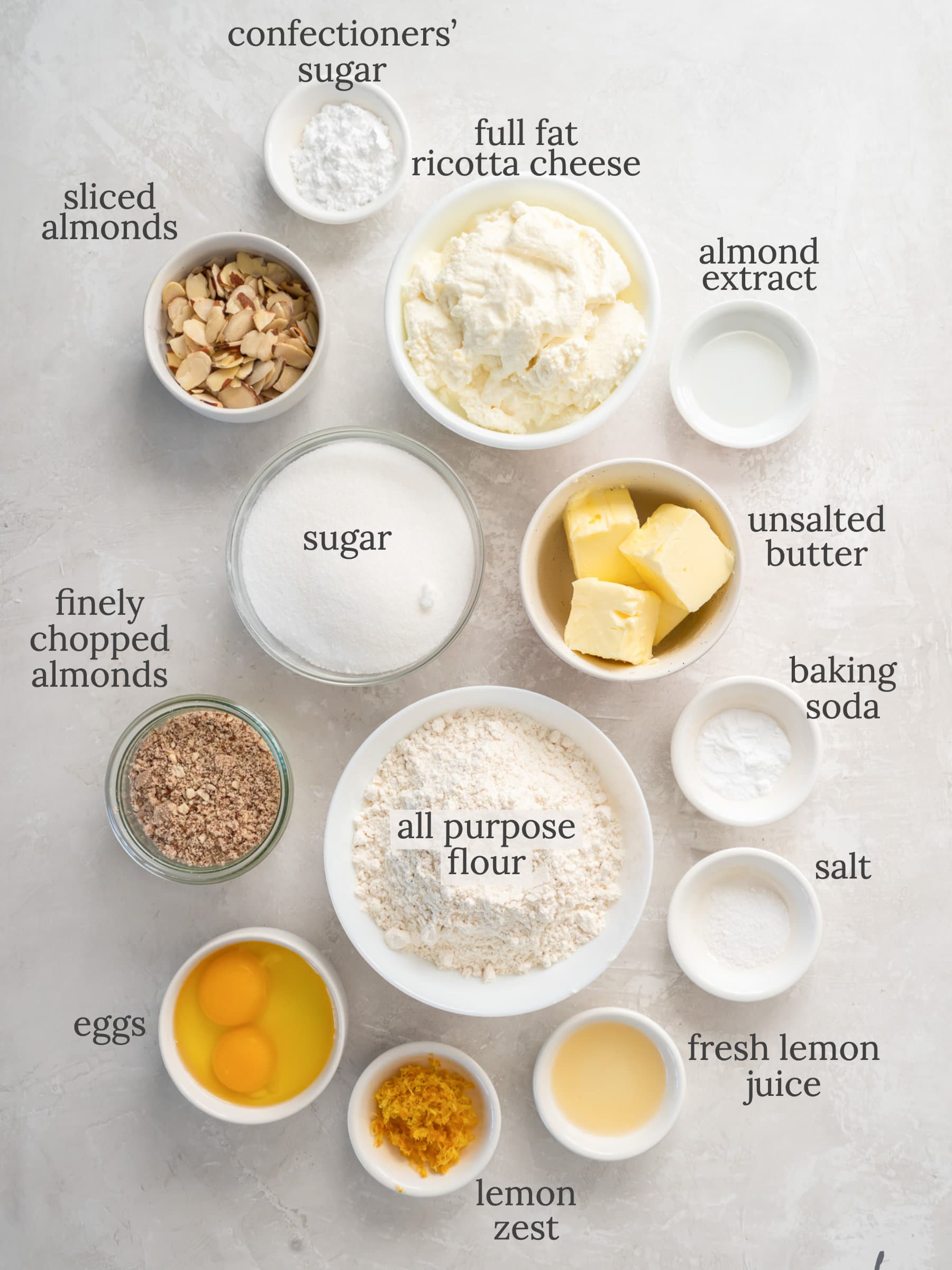 lemon ricotta cake ingredients in bowls with text.