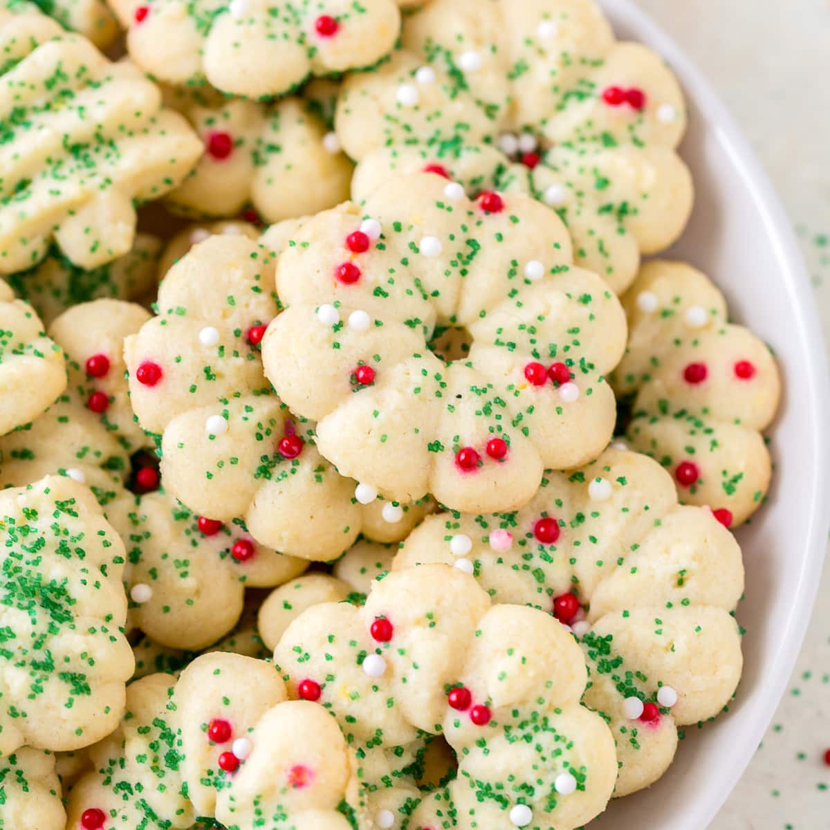 pile of spritz cookies with red and green sprinkles.