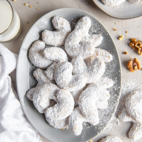 plate of vanillekipferl cookies with confectioners' sugar.