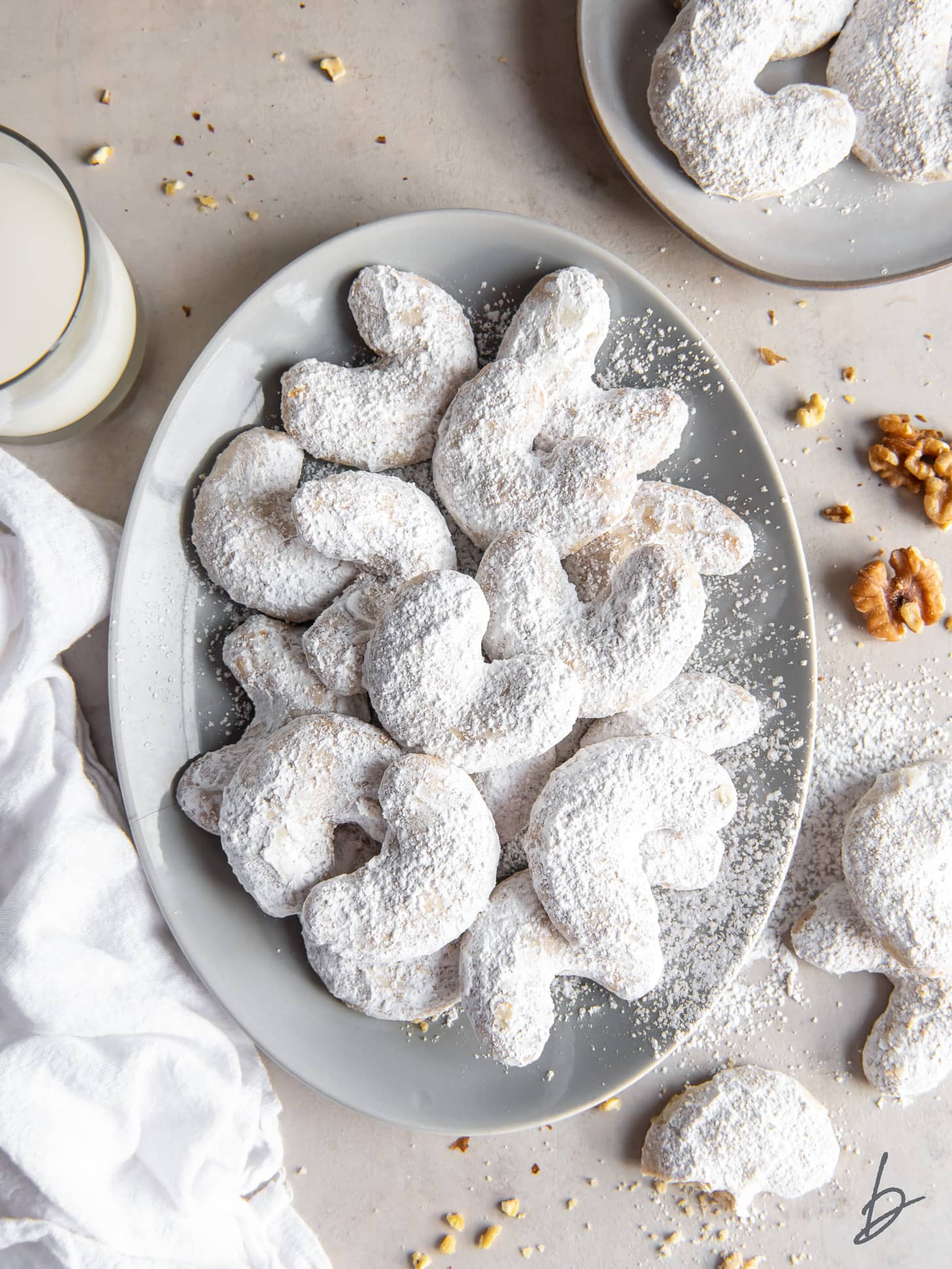 plate of vanillekipferl cookies with confectioners' sugar.