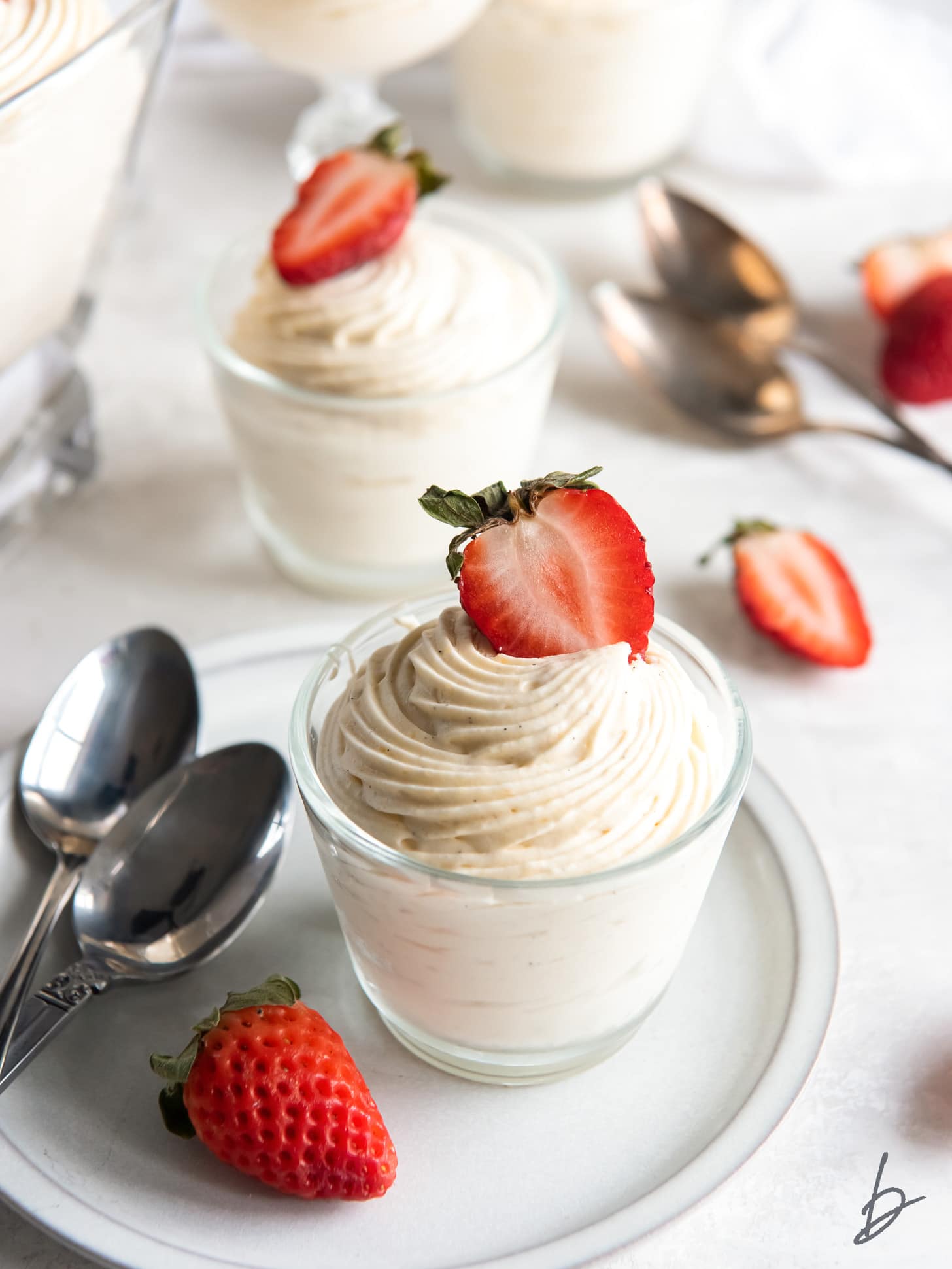 vanilla mousse in a glass jar with strawberry garnish.