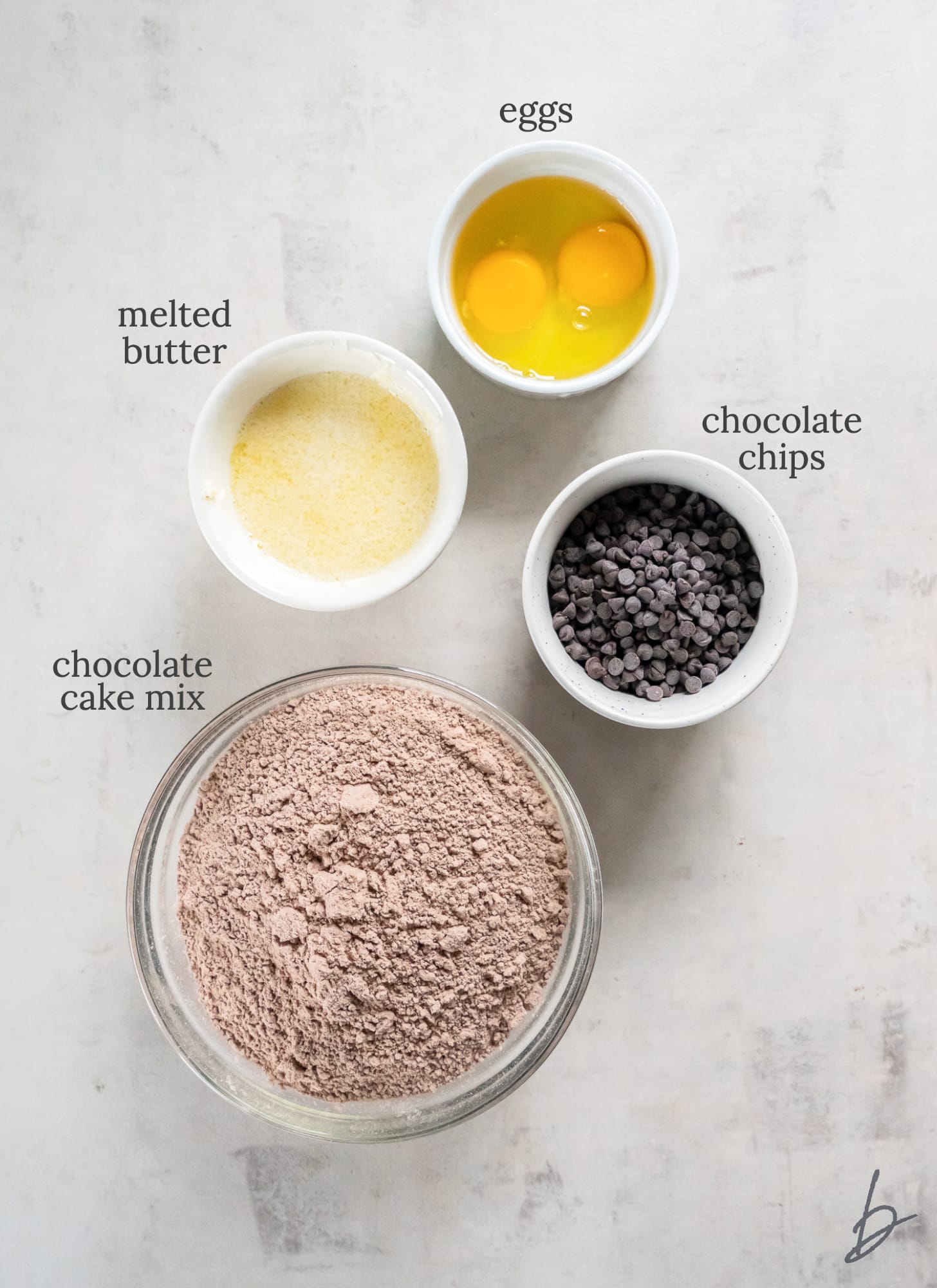 four ingredients in bowls for chocolate cake mix cookies.