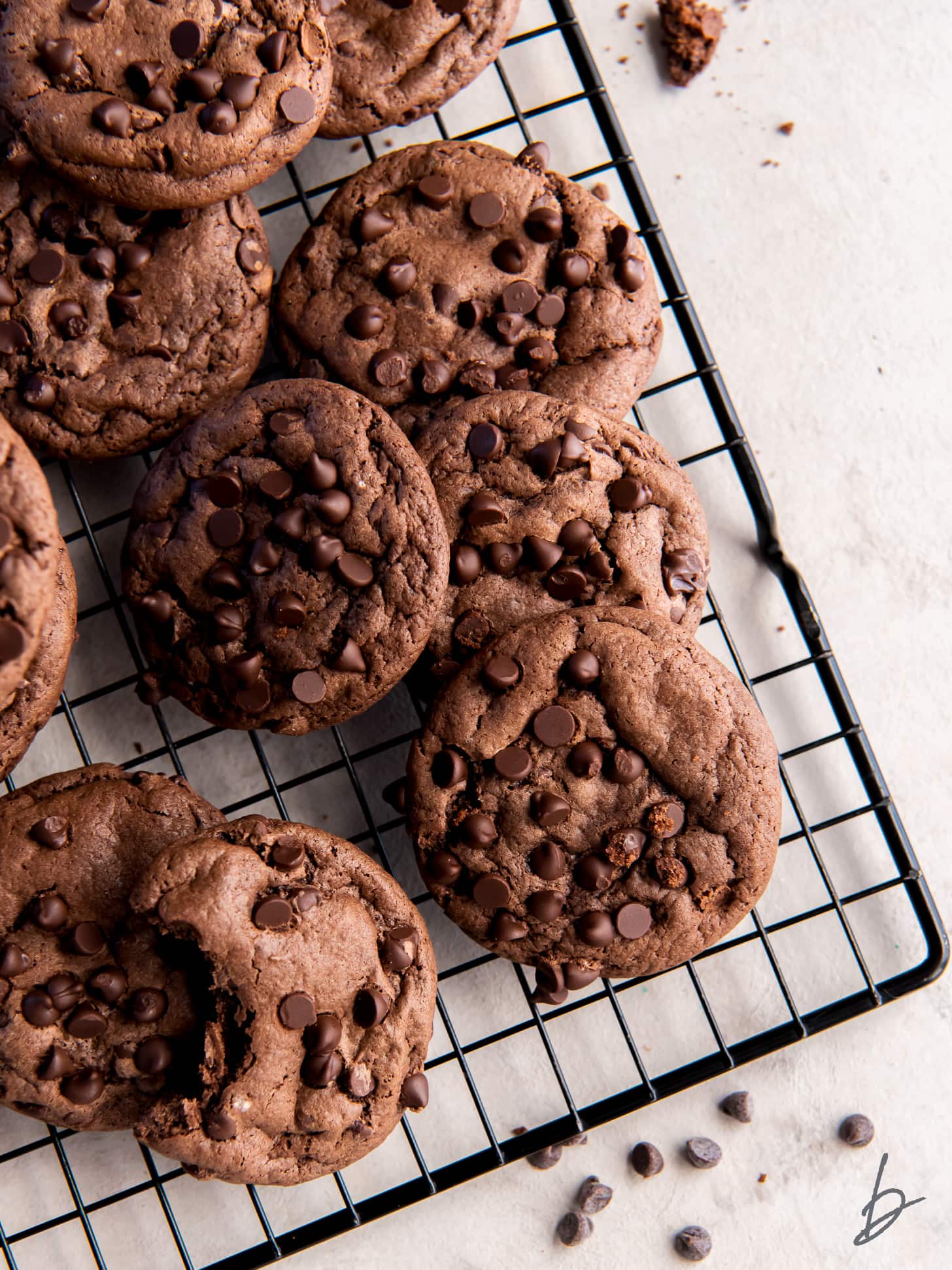 cooling rack with chocolate cake mix cookies with chocolate chips.