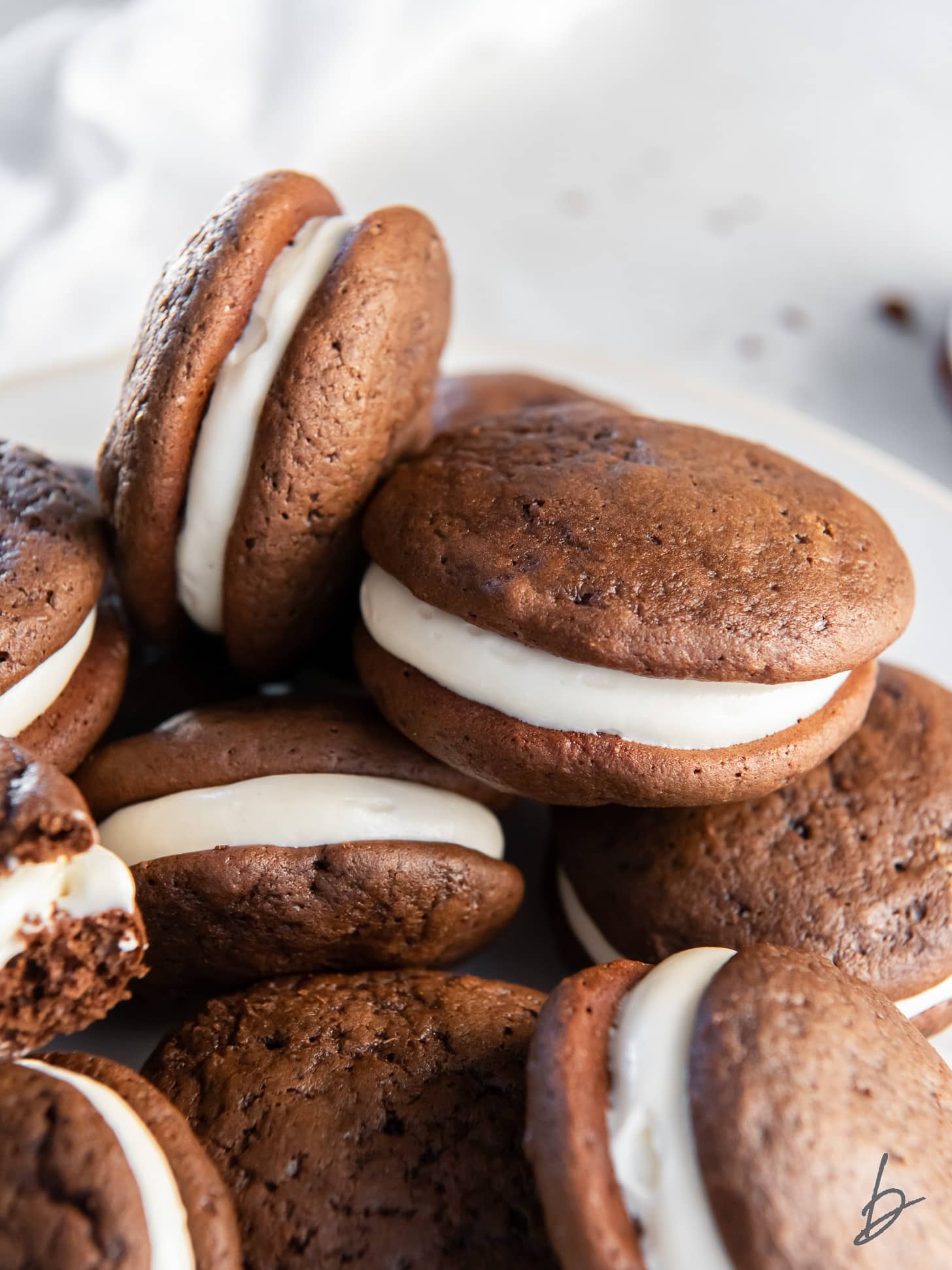 pile of soft chocolate whoopie pies with cream cheese filling.