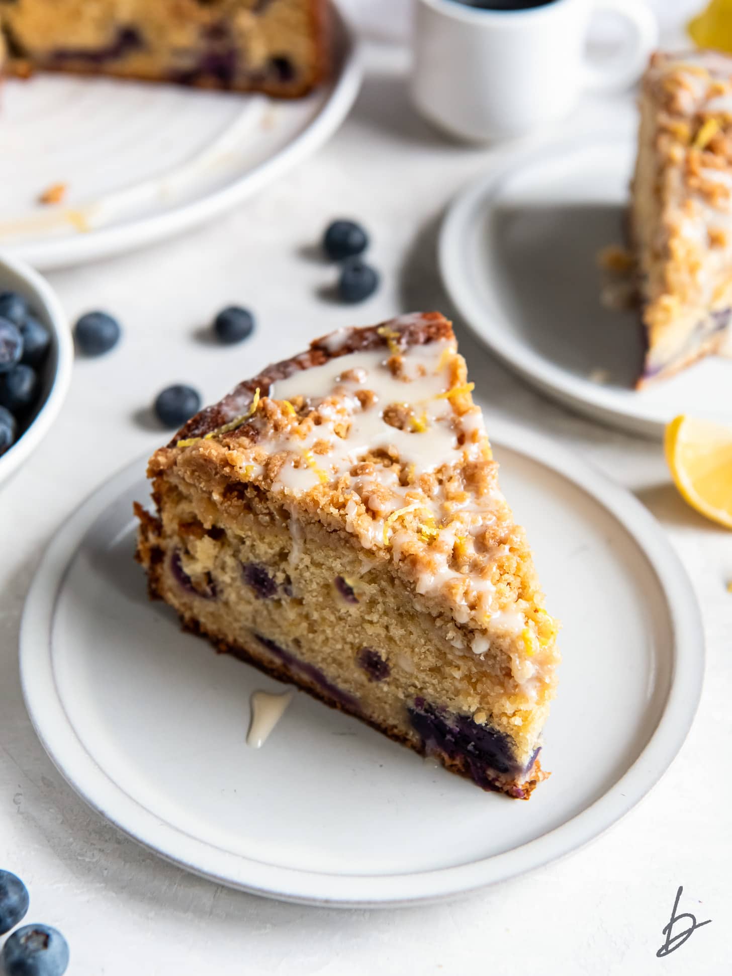 slice of blueberry buckle coffee cake with streusel and glaze.