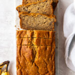 loaf of buttermilk banana bread with a couple slices cut off the end.