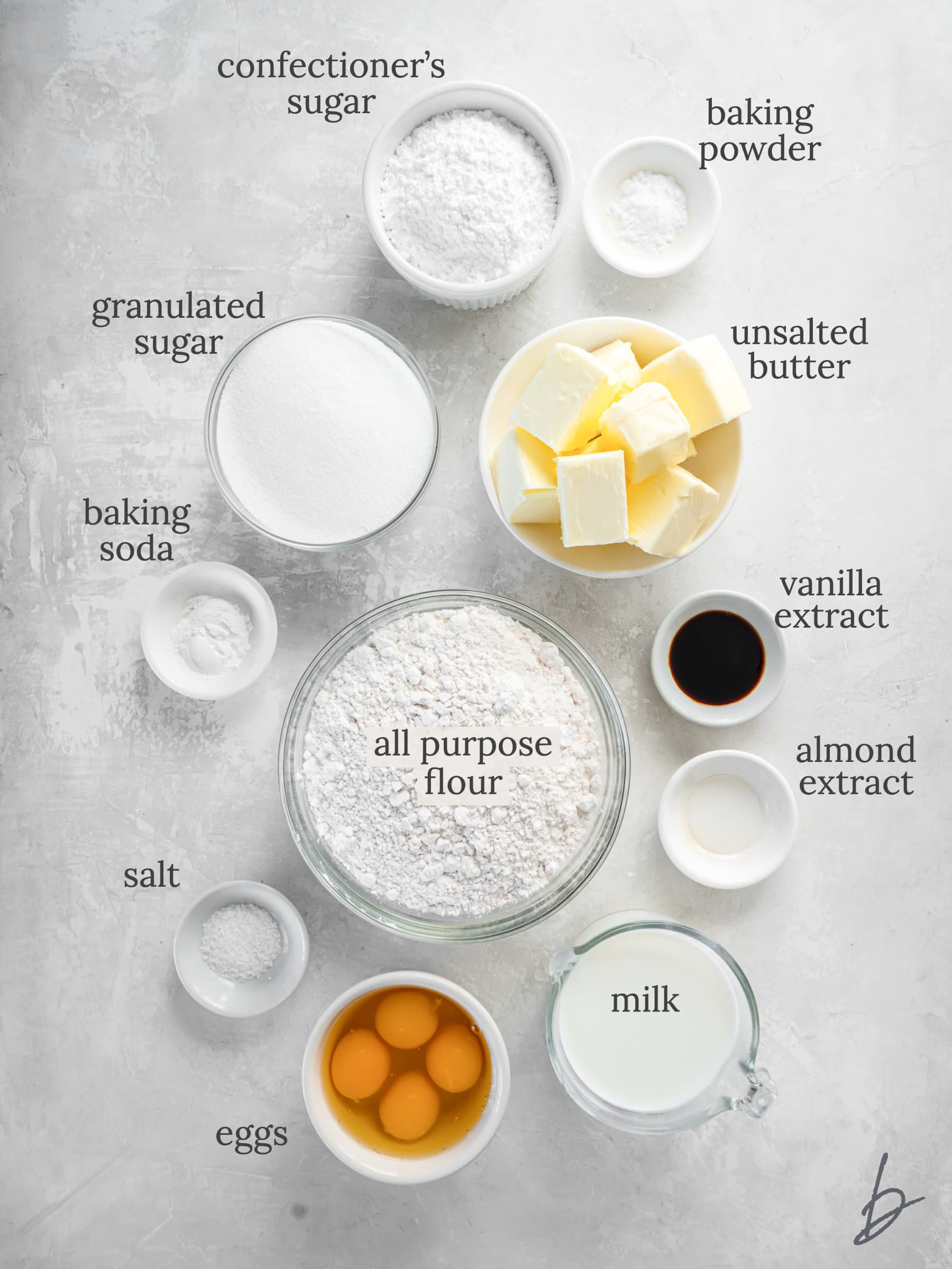 vanilla bundt cake ingredients in bowls labeled with text.