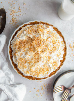 coconut cream pie with whipped cream topping and toasted coconut garnish.