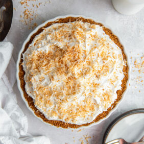 coconut cream pie with whipped cream topping and toasted coconut garnish.