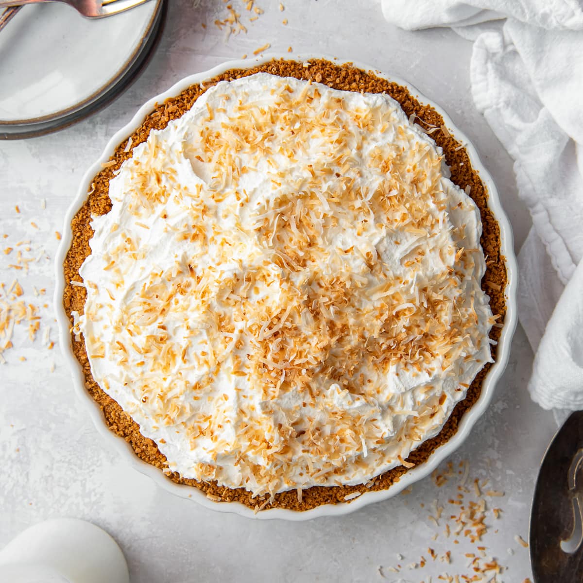 coconut cream pie with whipped cream and toasted coconut on top.
