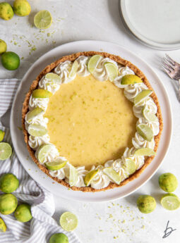 key lime pie whipped cream and lime wedges as garnish.