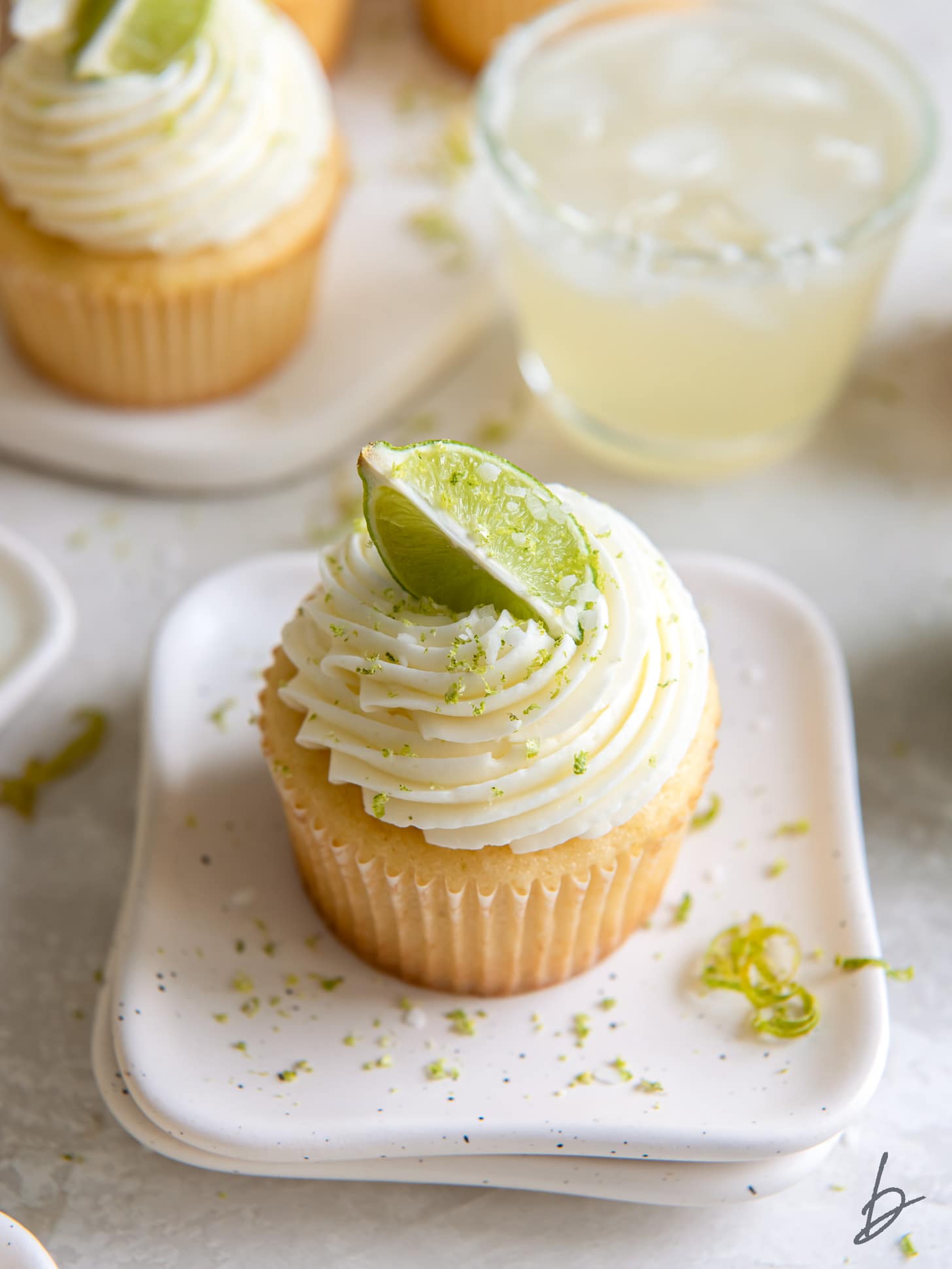 margarita cupcakes with lime slice and zest as garnish.