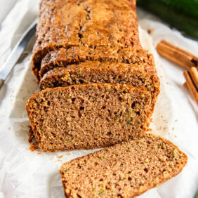 loaf of cinnamon zucchini bread with slices cut off the end.