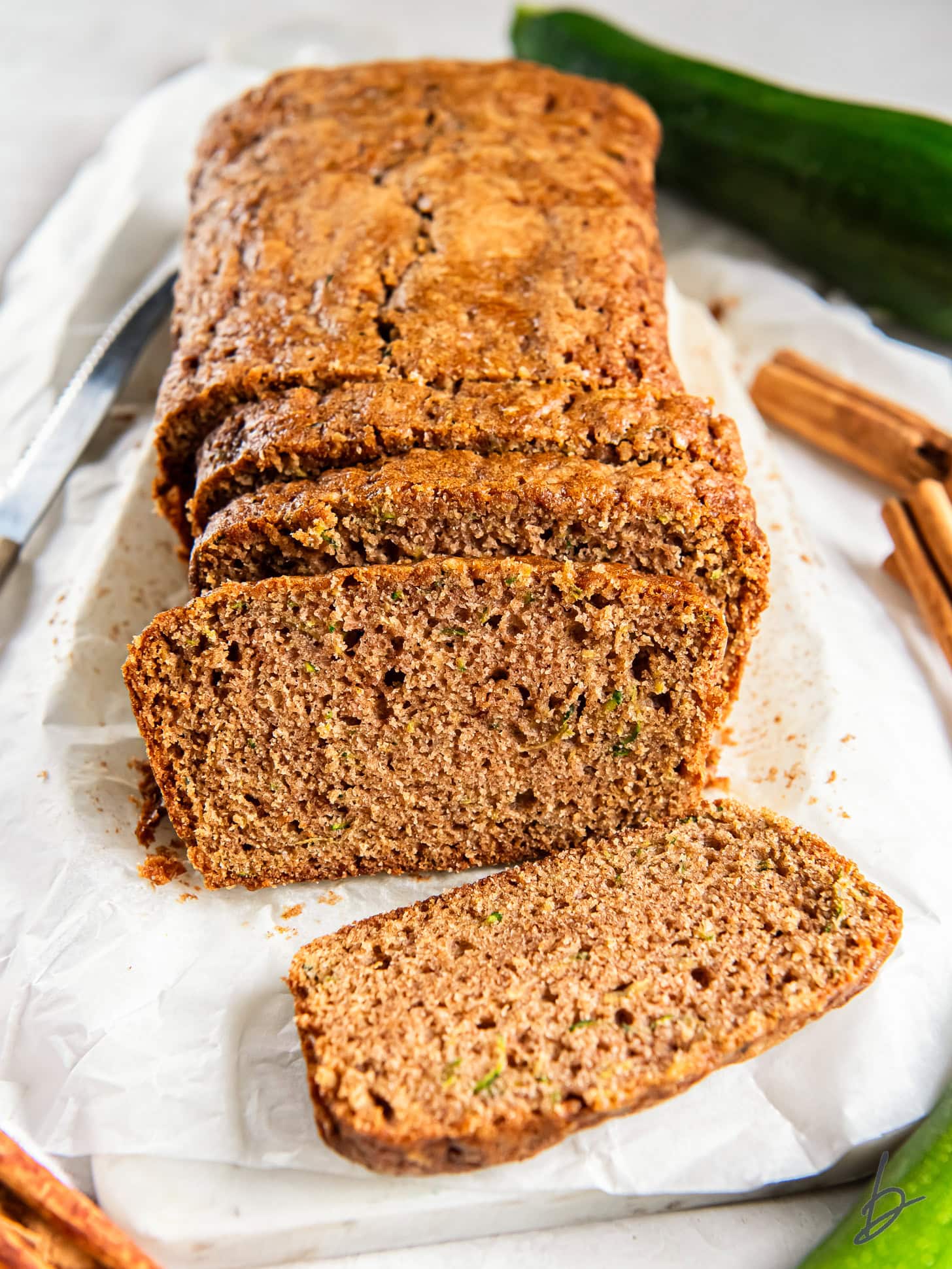 loaf of cinnamon zucchini bread with slices cut off the end.