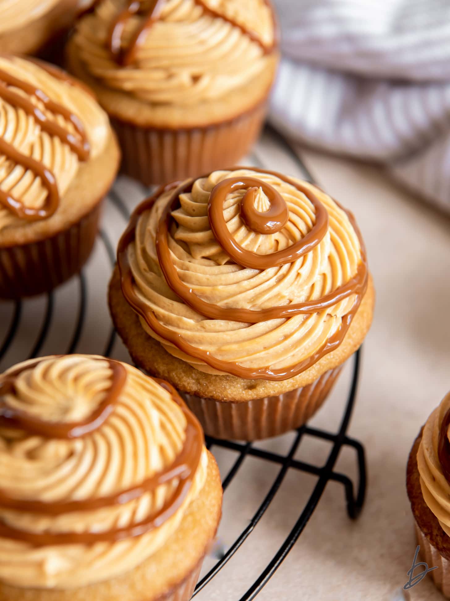 dulce de leche cupcake with frosting and swirl of dulce de leche on top.