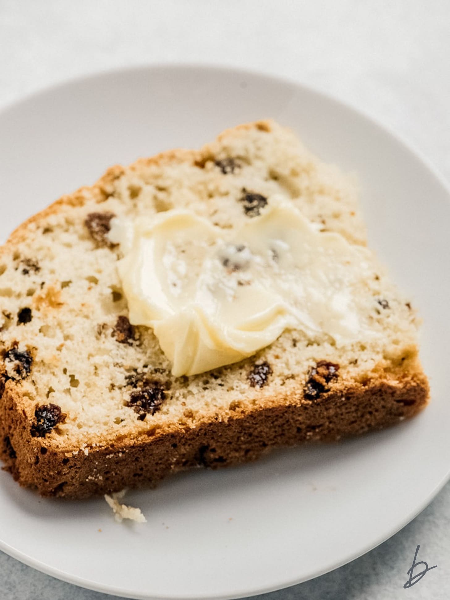 slice of irish soda bread with butter spread on top.