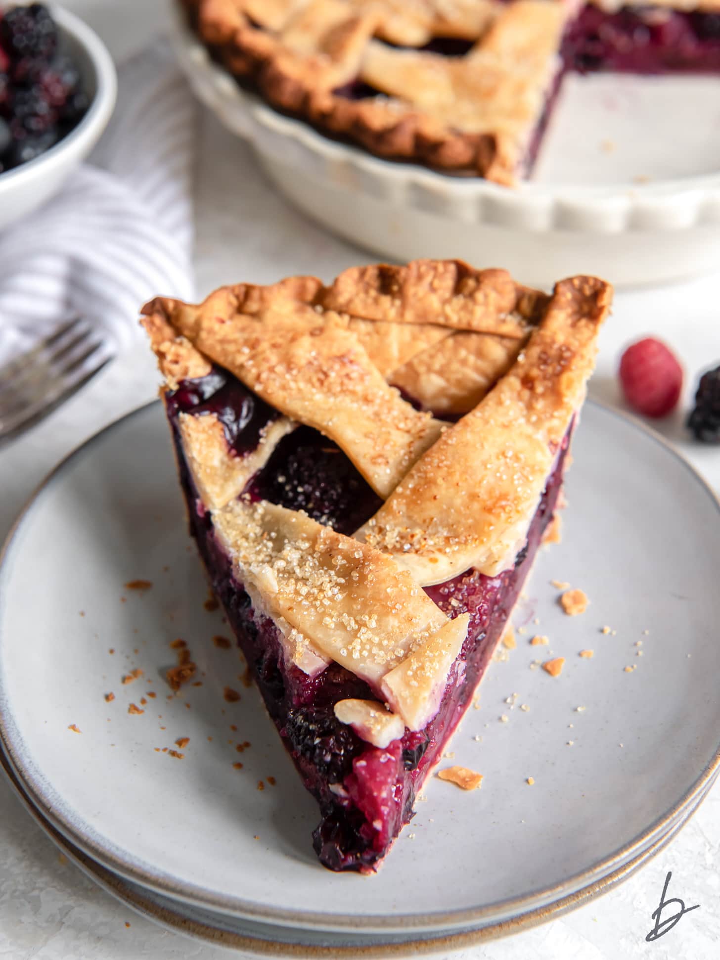 slice of berry pie on round plate.