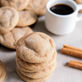 stack of chewy snickerdoodle cookies with cracked tops and cinnamon sugar.