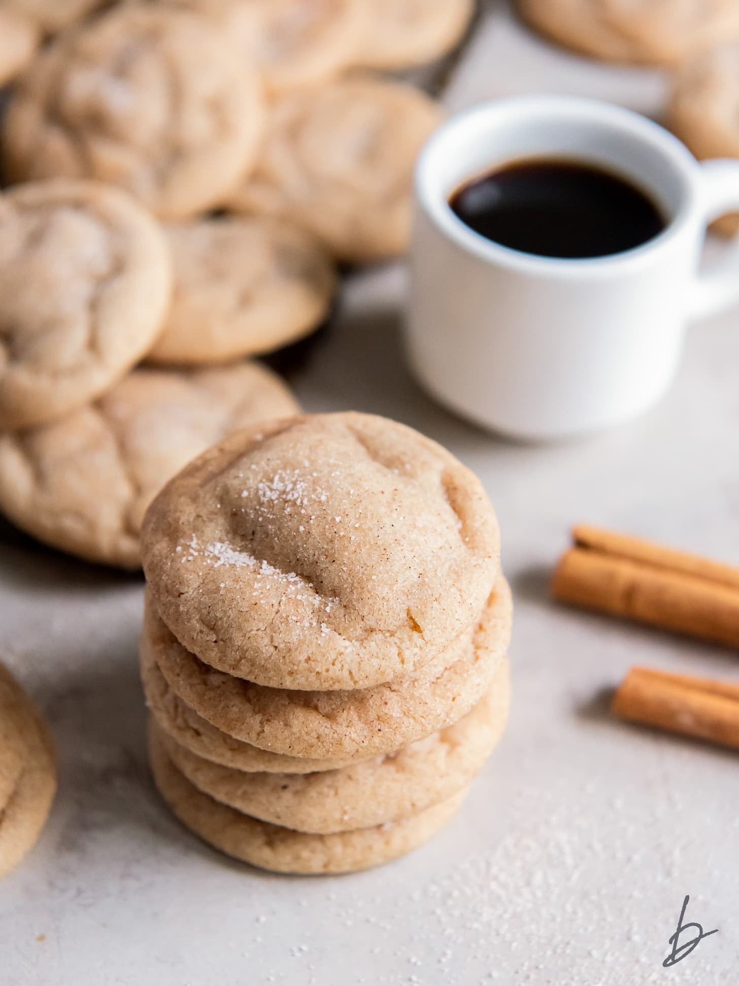 stack of chewy snickerdoodle cookies with cracked tops and cinnamon sugar.