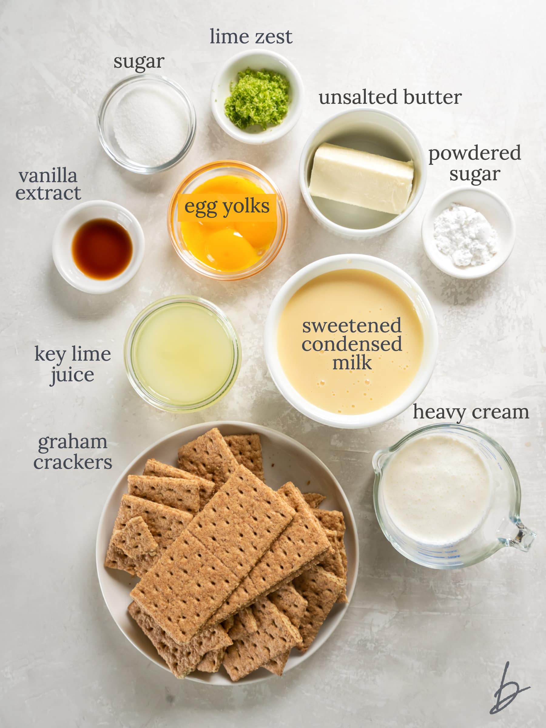 bowls of ingredients to make key lime pie with graham cracker crust.