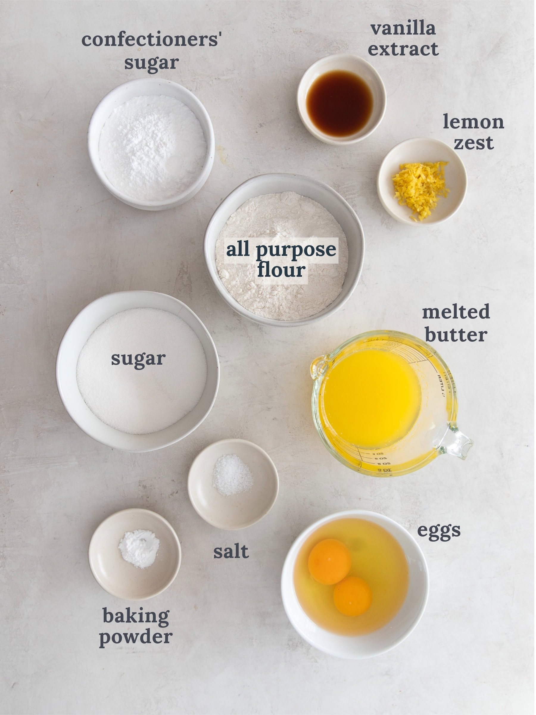 ingredients to make madeleine cookies labeled with text