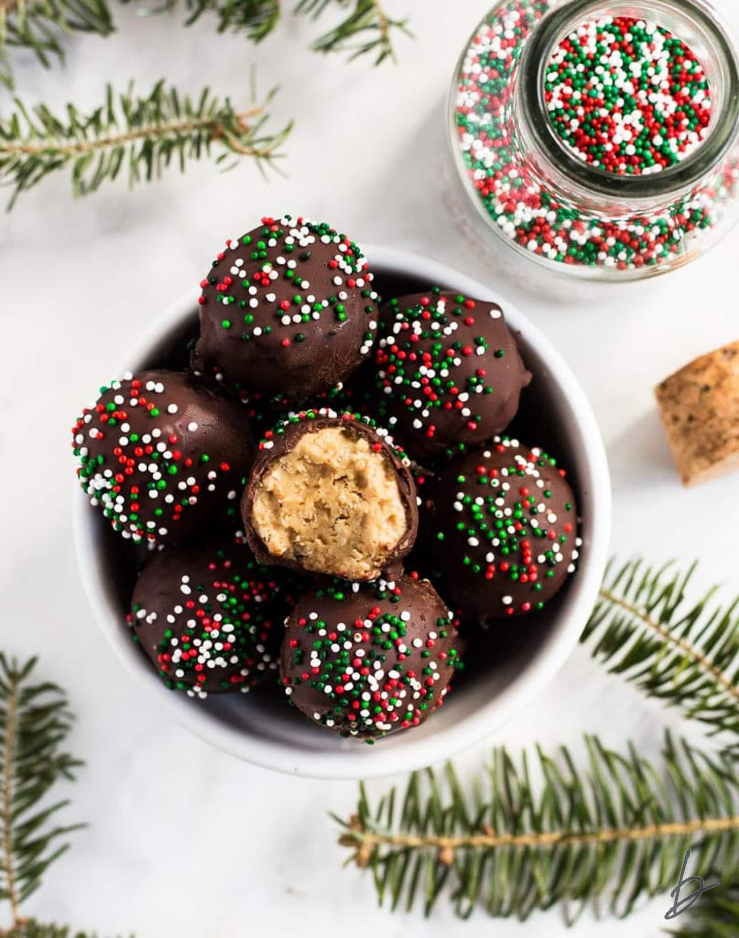 no bake peanut butter balls in a bowl and top truffle with a bite.