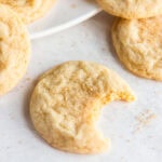 sugar cookie with a bite on tabletop.