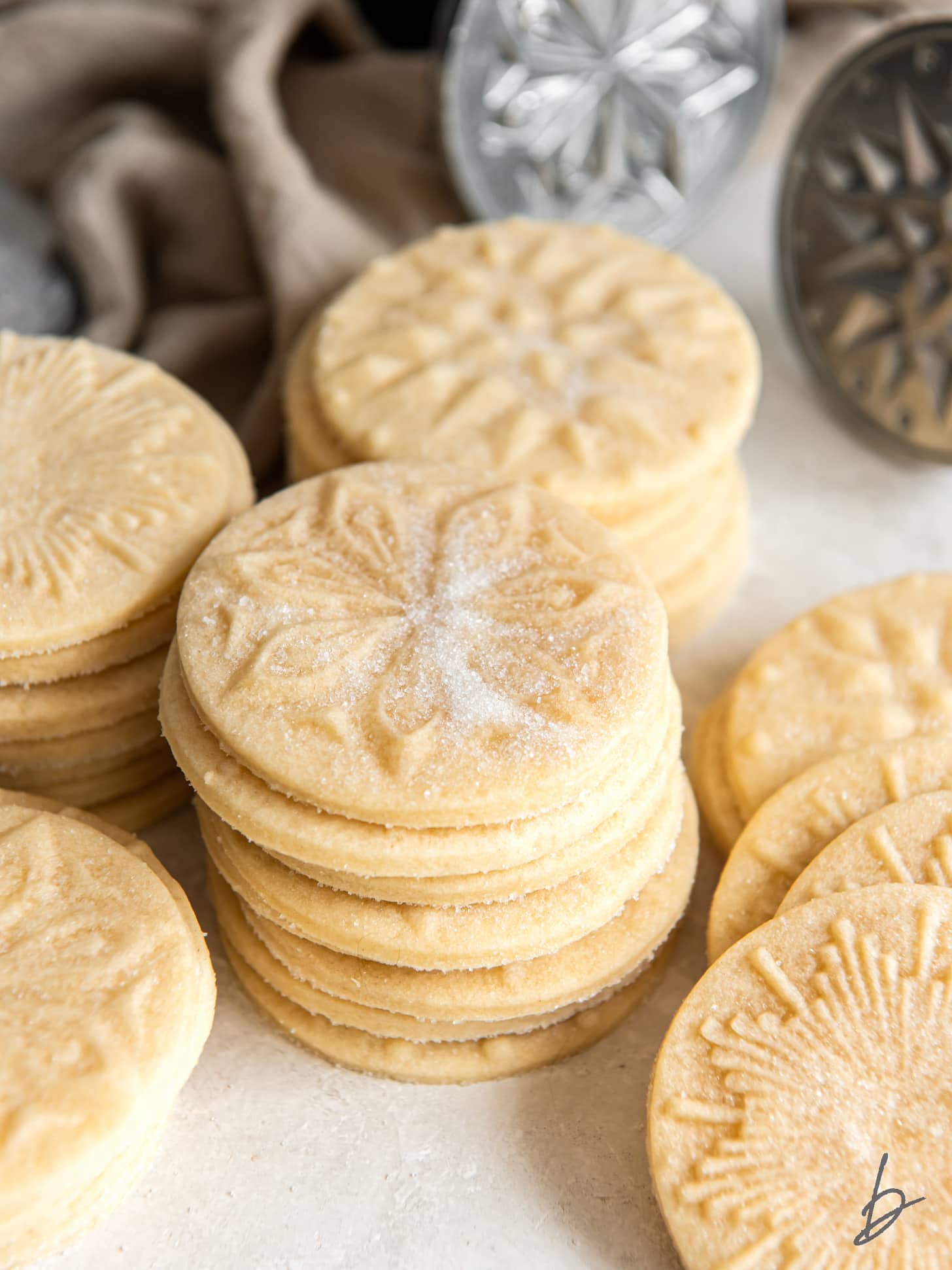 stacks of shortbread stamped cookies in front of nordicware stamps.