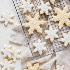 decorated snowflake sugar cookies on cooling.