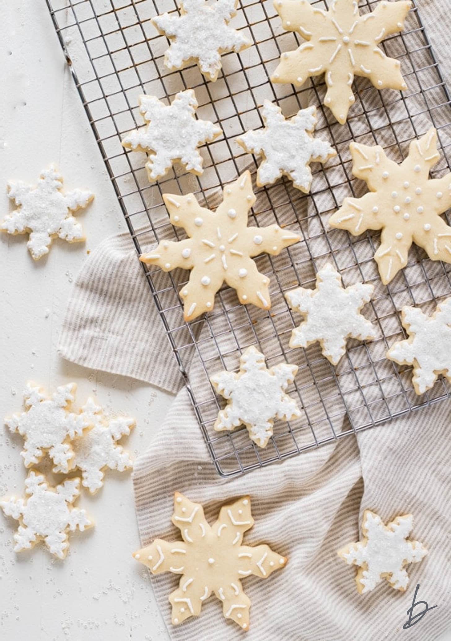 decorated snowflake sugar cookies on cooling.