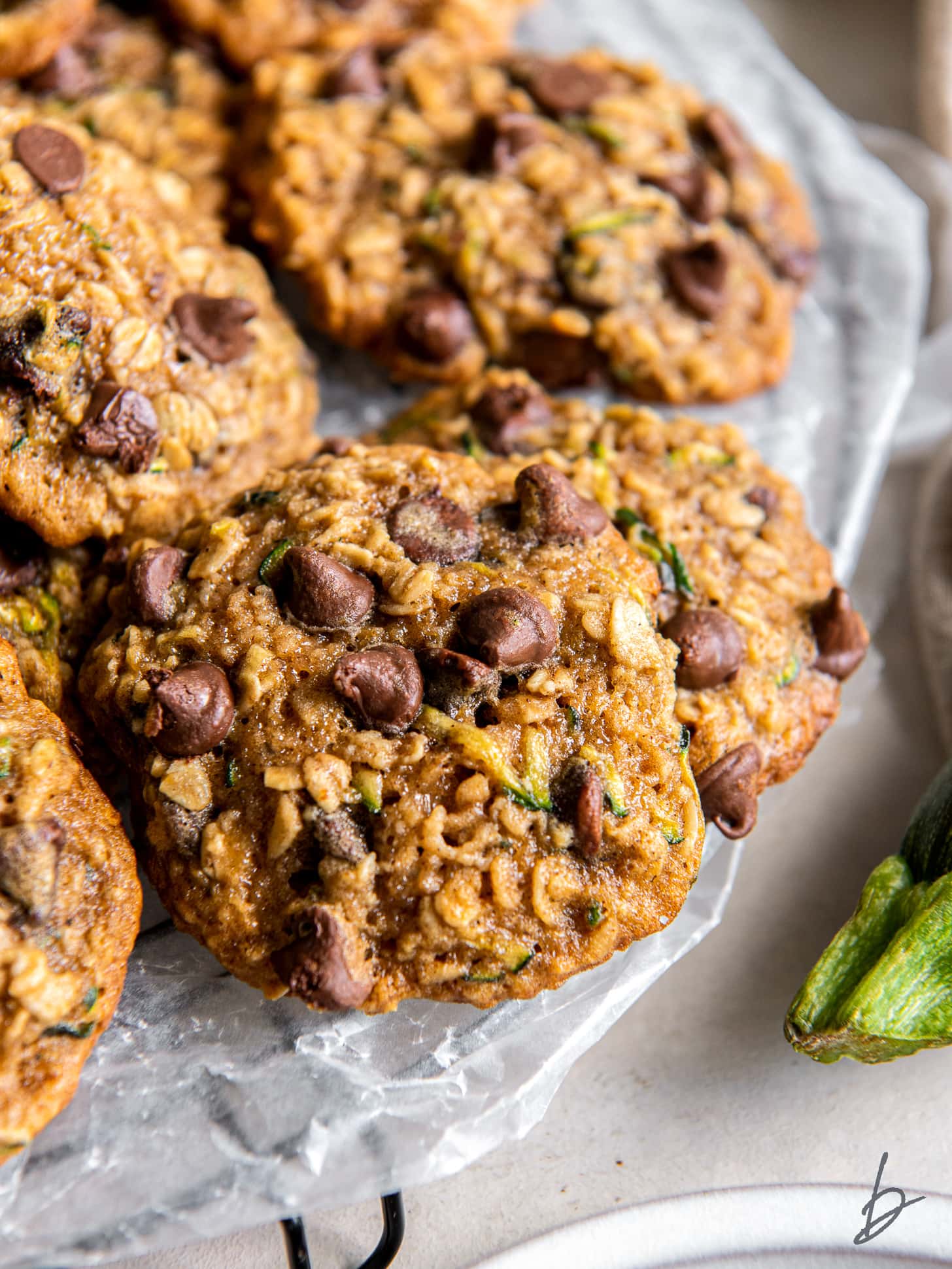 pile of chewy zucchini cookies with chocolate chips and oats.