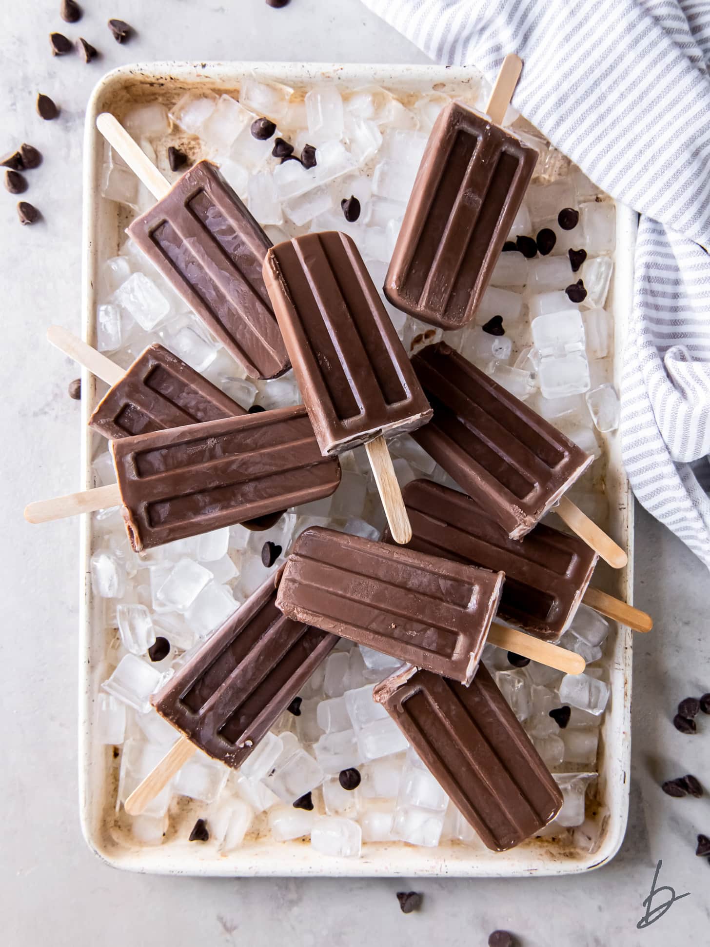 fudgesicles on a baking sheet with ice cubes.