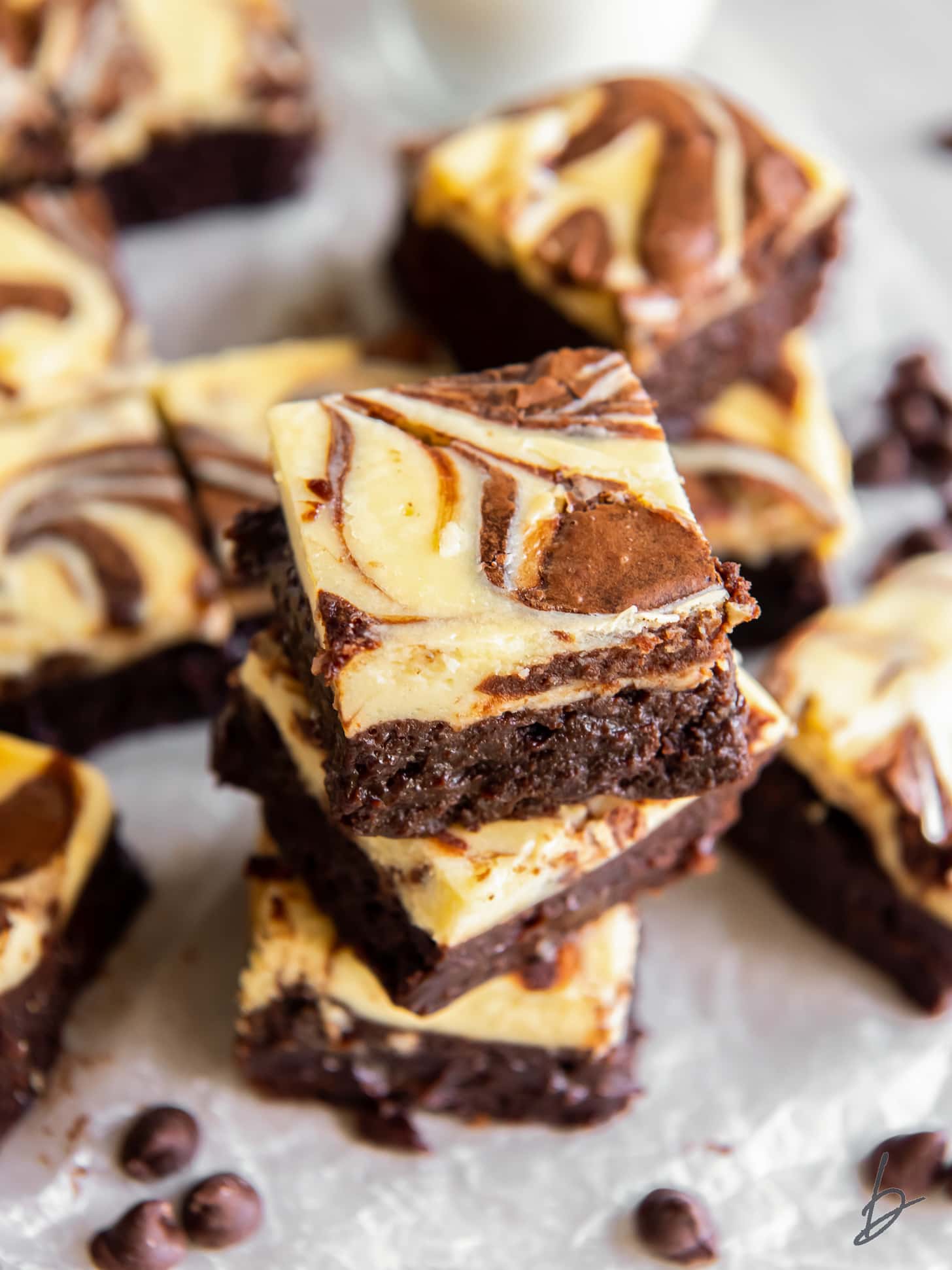 stack of cream cheese brownies with swirl on tops.