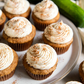 plate of zucchini cupcakes with cream cheese frosting.