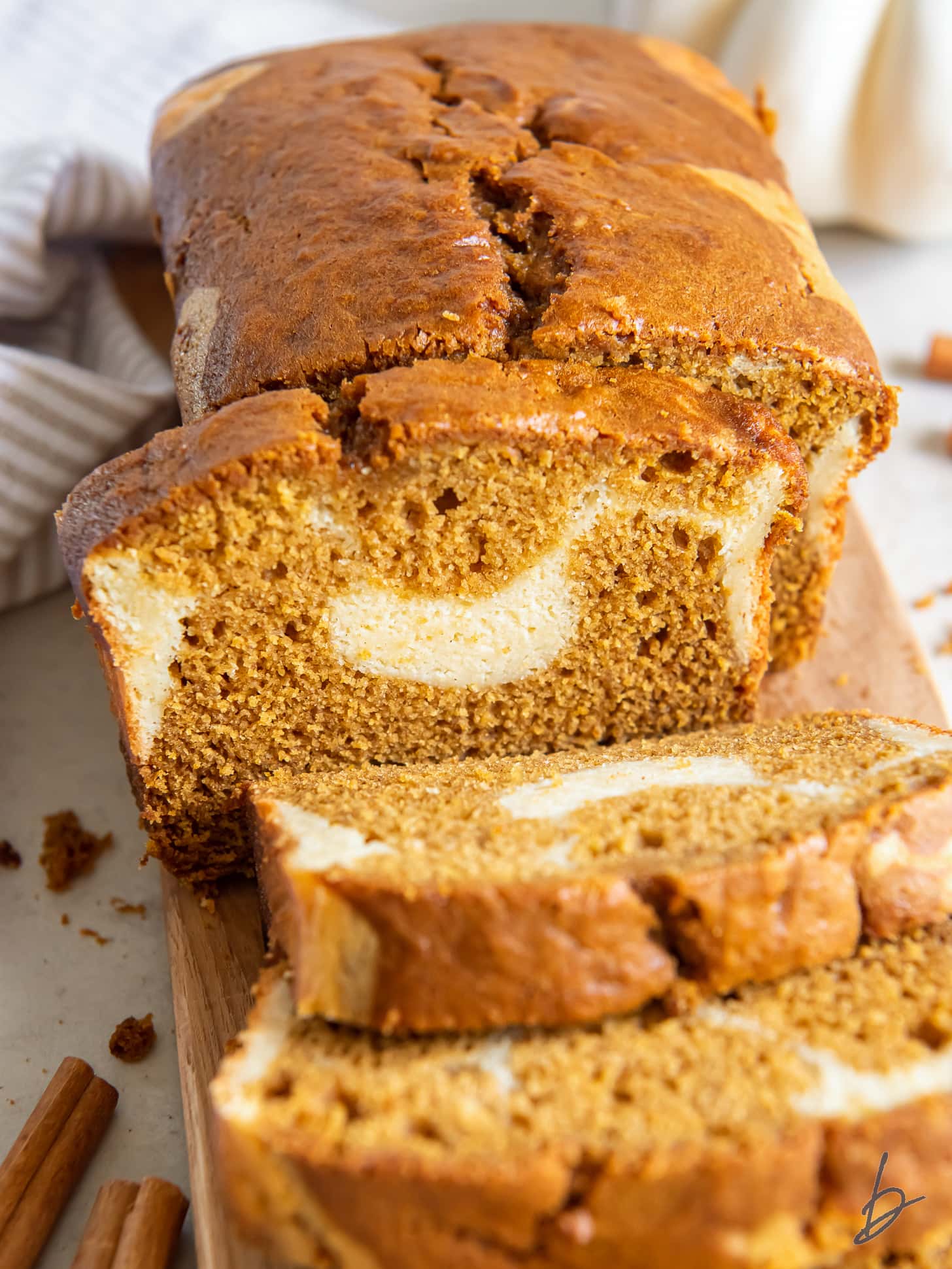 slices of pumpkin bread with cream cheese swirl inside leaning against each other.