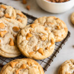 butterscotch chip cookies in a pile on small wire rack.