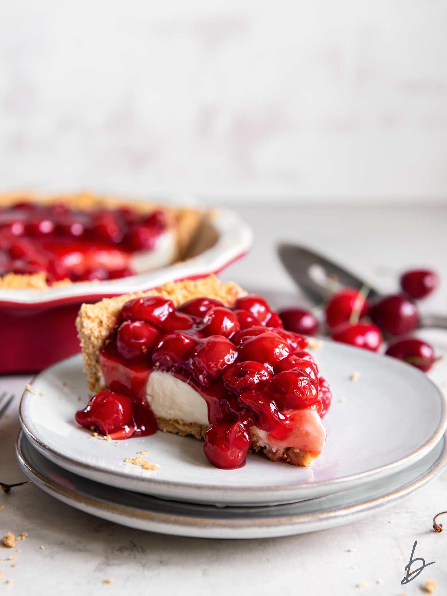 slice of cherry cream cheese pie on a plate.