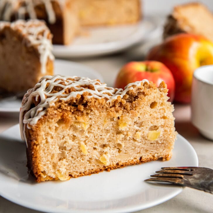 slice of apple coffee cake with streusel on a plate.