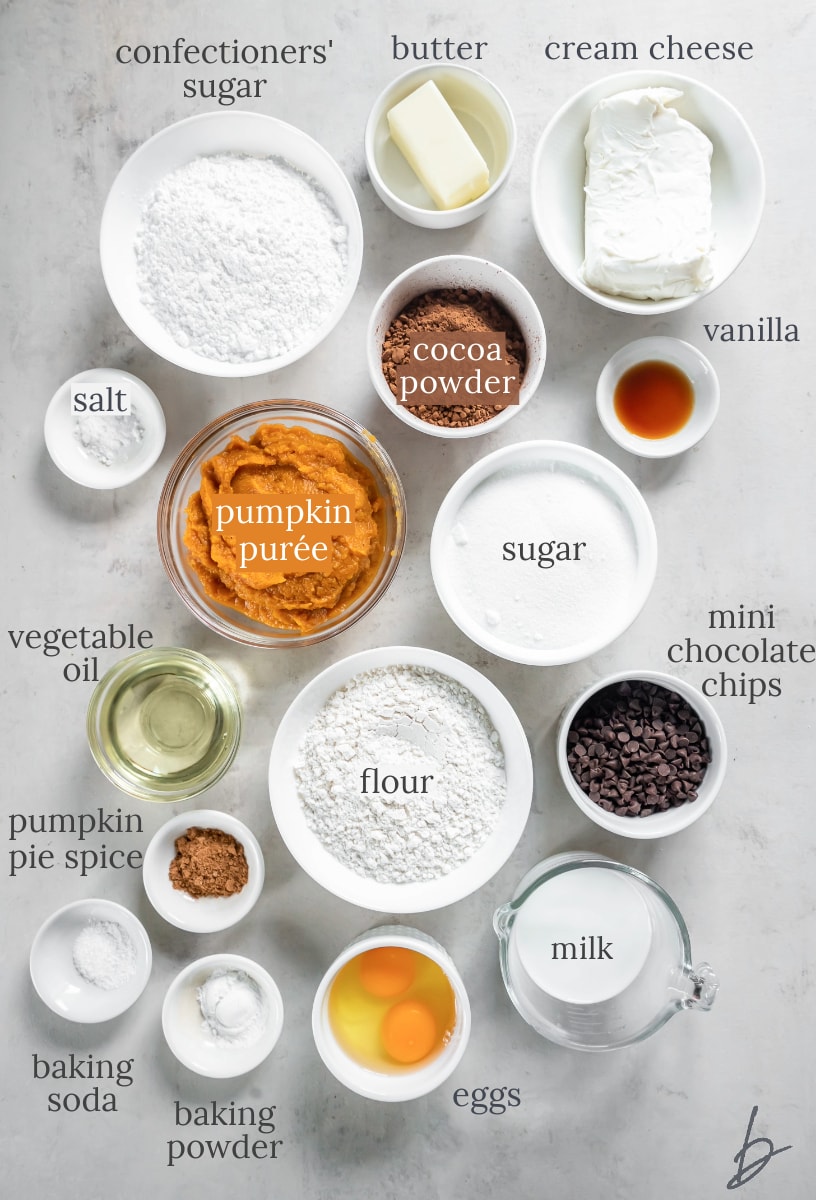 bowls of ingredients to make chocolate pumpkin cake and pumpkin cream cheese frosting.