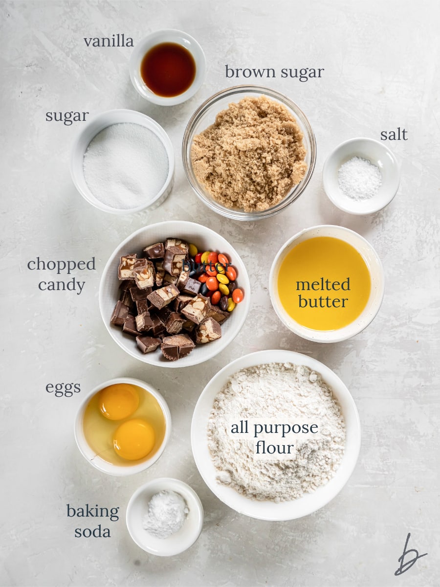 bowls of ingredients to make halloween candy cookie bars.