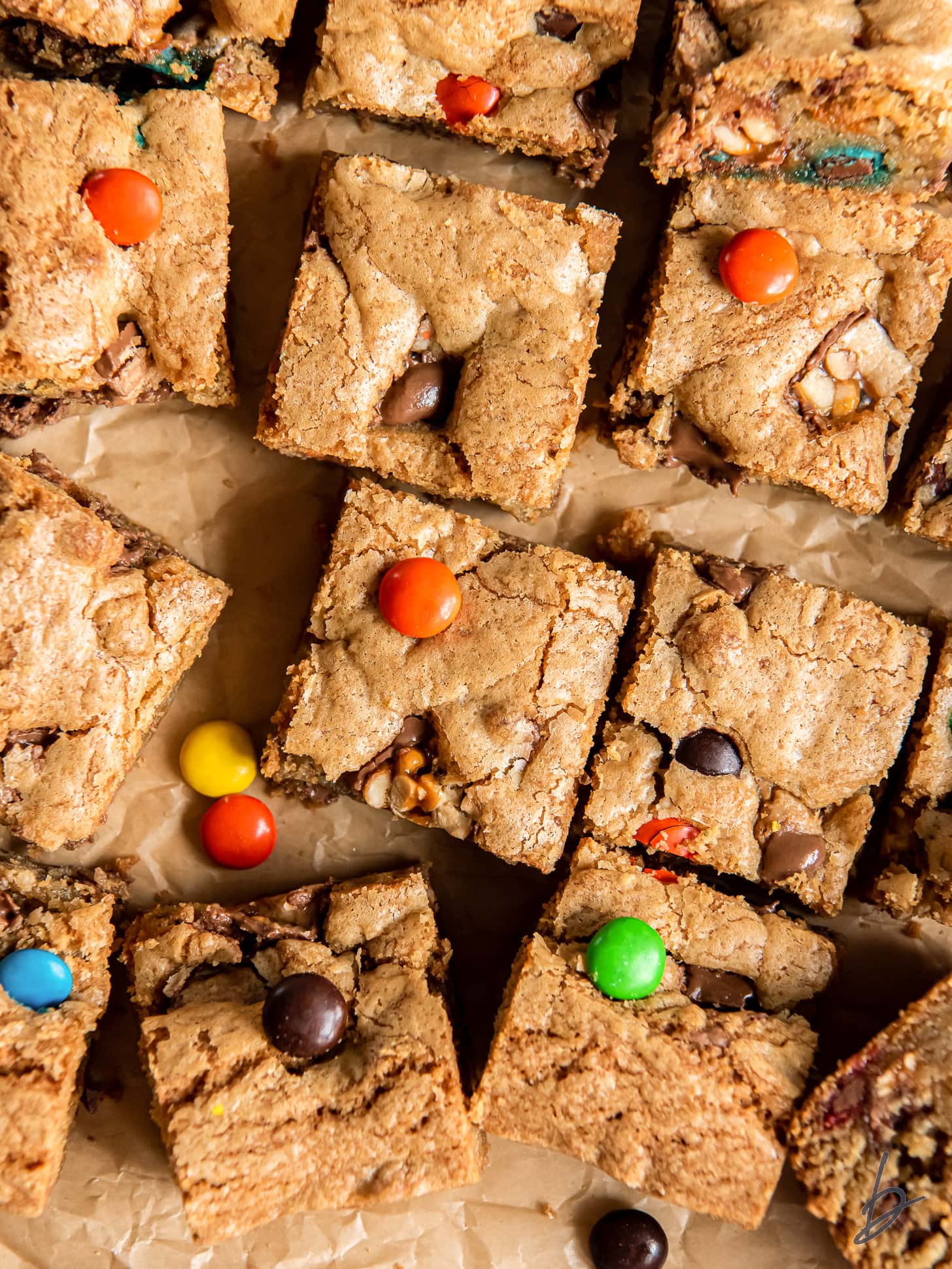 leftover halloween candy cookie bars on parchment paper with m&ms.
