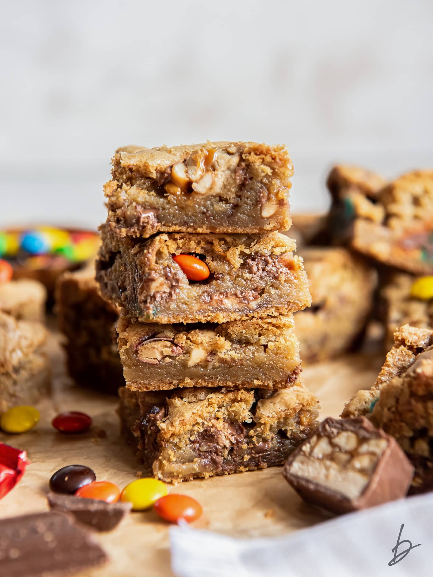 stack of halloween candy cookie bars loaded with chopped chocolate candies.