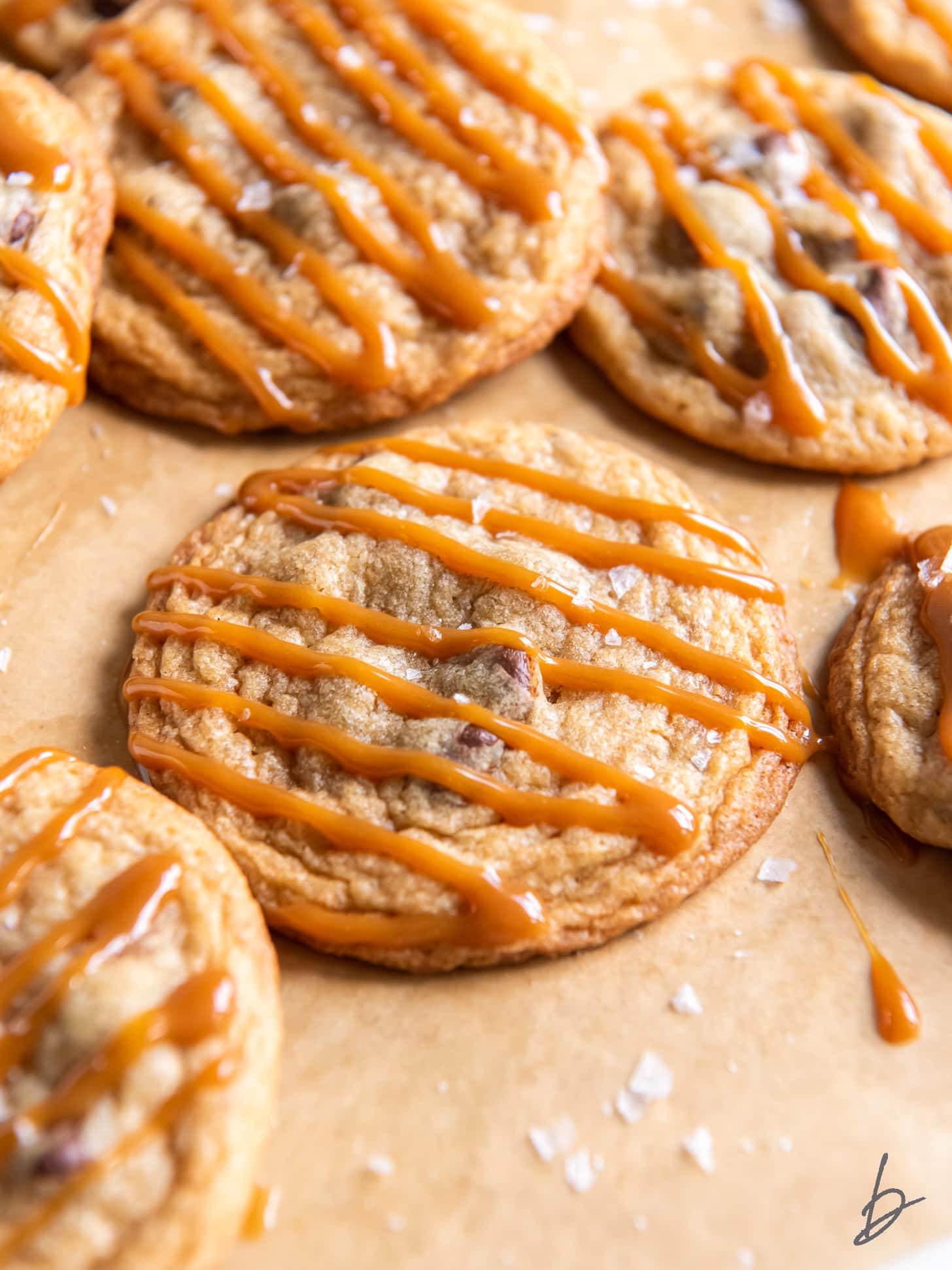 chocolate chip caramel cookie with caramel drizzled on top.