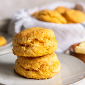 stack of two fluffy sweet potato biscuits on a small gray plate.