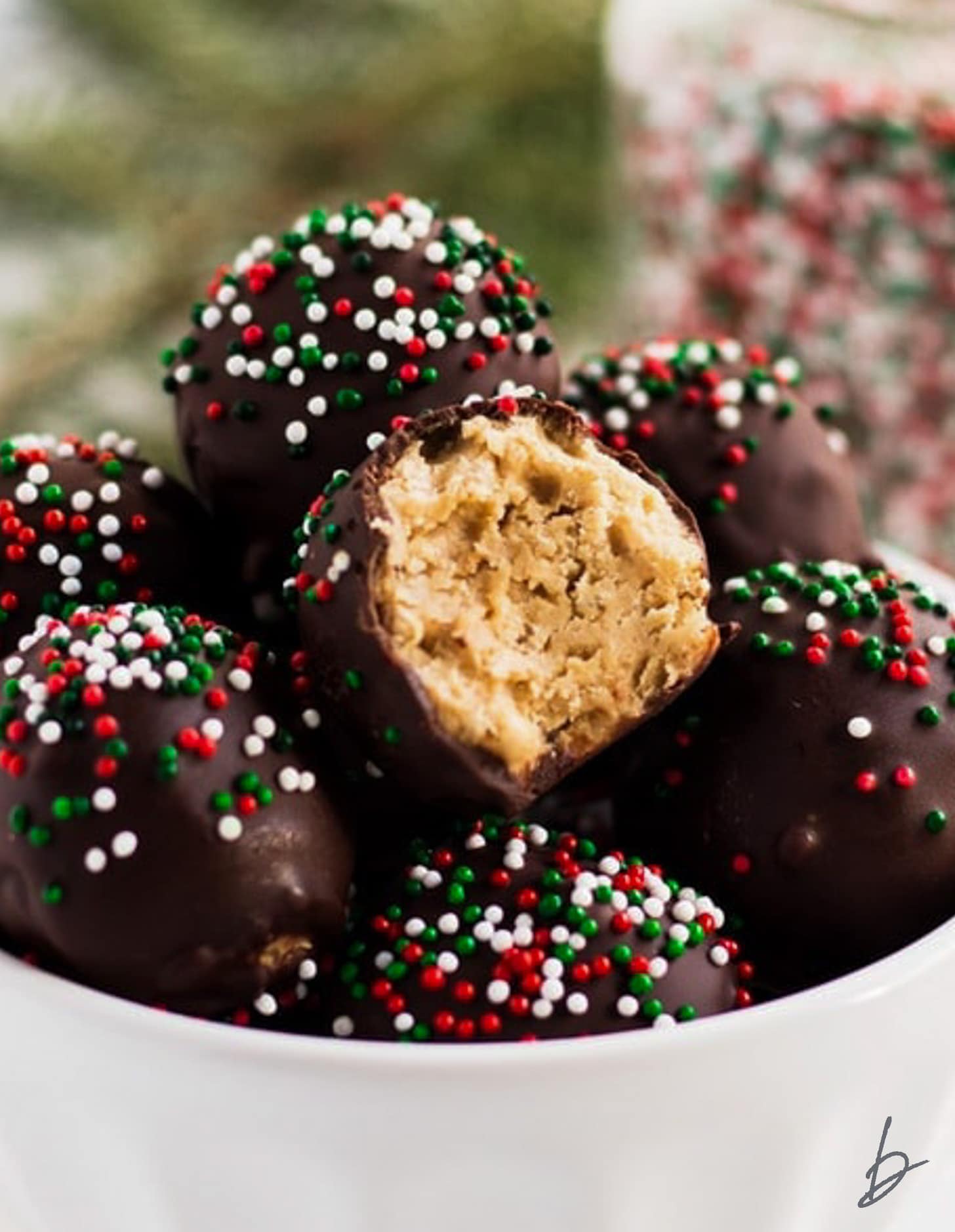 no bake peanut butter ball with a bite taken out of it showing rice krispies inside.