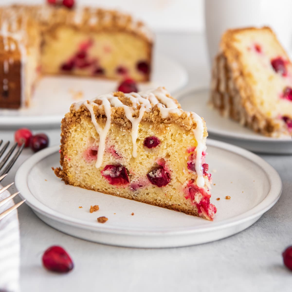 slice of cranberry coffee cake on a plate.
