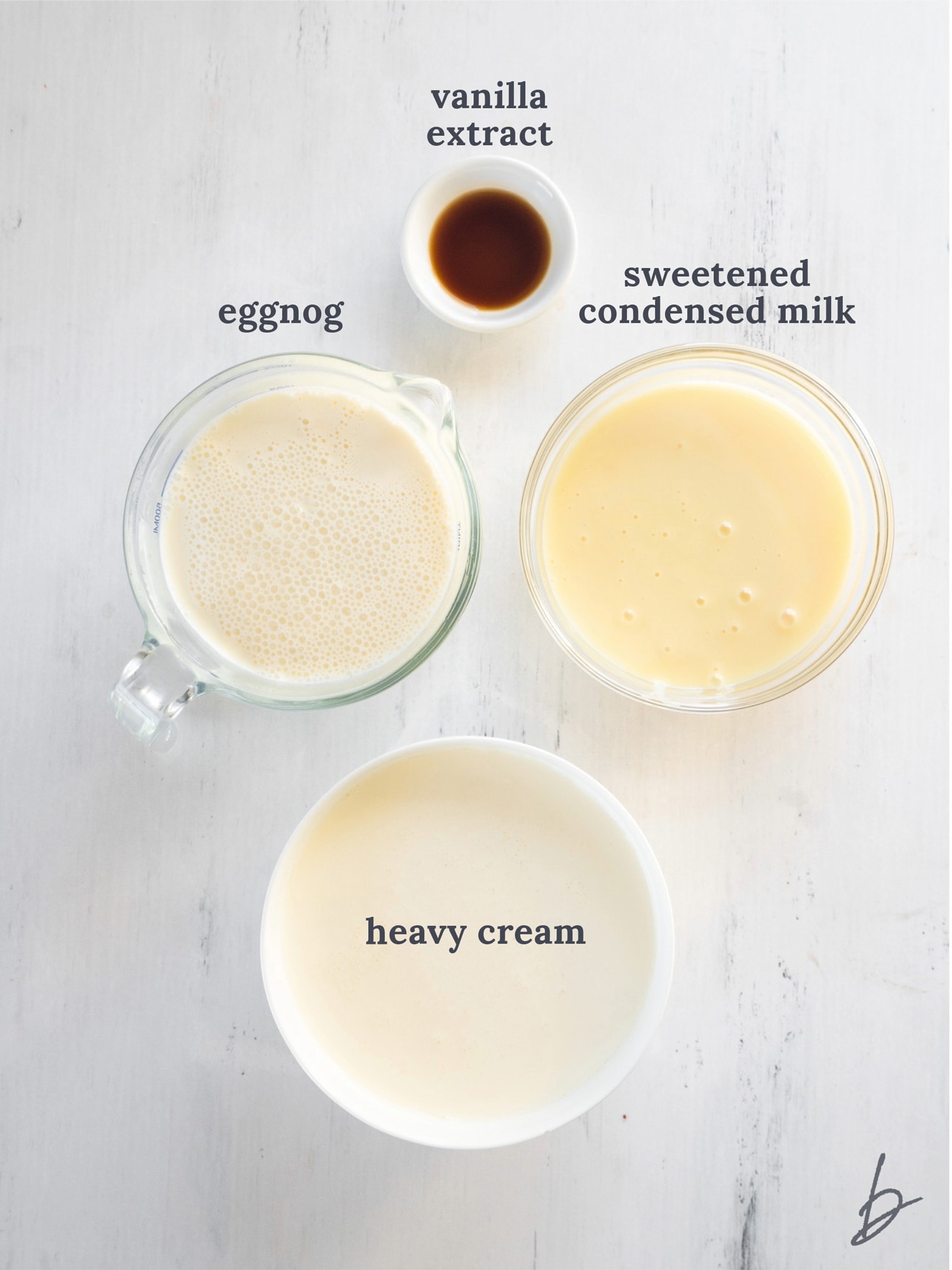 bowls of ingredients to make eggnog ice cream.
