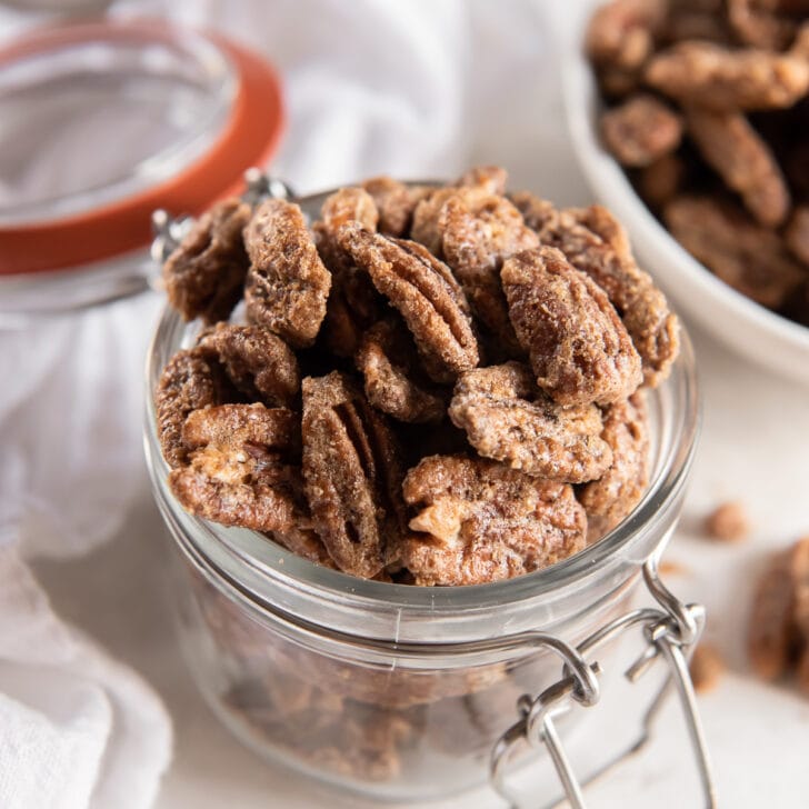 glass jar filled with spiced pecans.