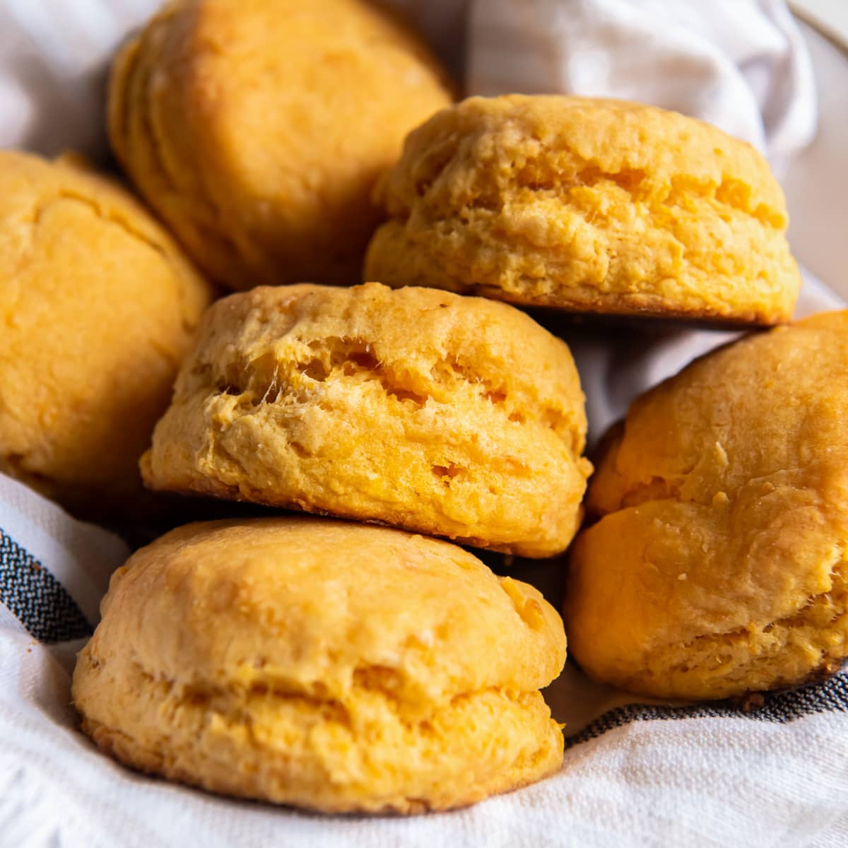 several sweet potato biscuits on a kitchen cloth in a basket.