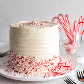 chocolate peppermint cake with white chocolate buttercream frosting and crushed peppermint candy as garnish.